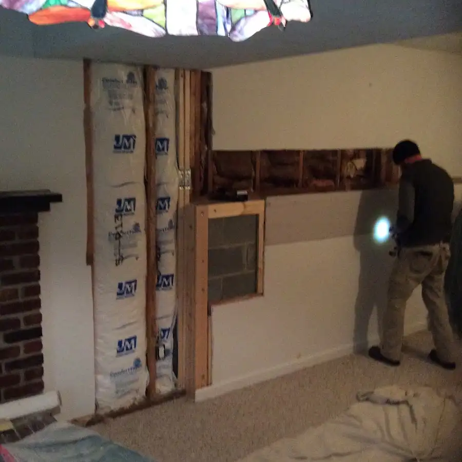 Restoration technician inspecting water damage in Lake Zurich
